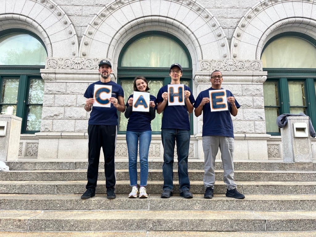 CAHE team members holding letters spelling CAHE on courthouse steps