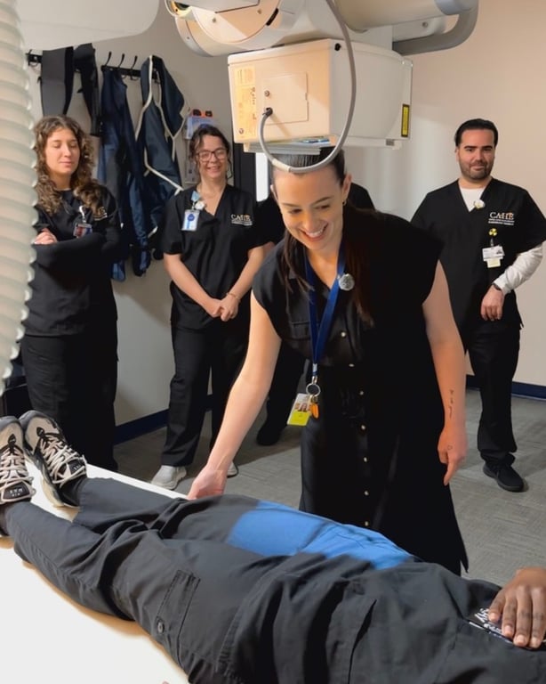 CAHE instructor demonstrating X-ray positioning to radiography students in a digital imaging lab